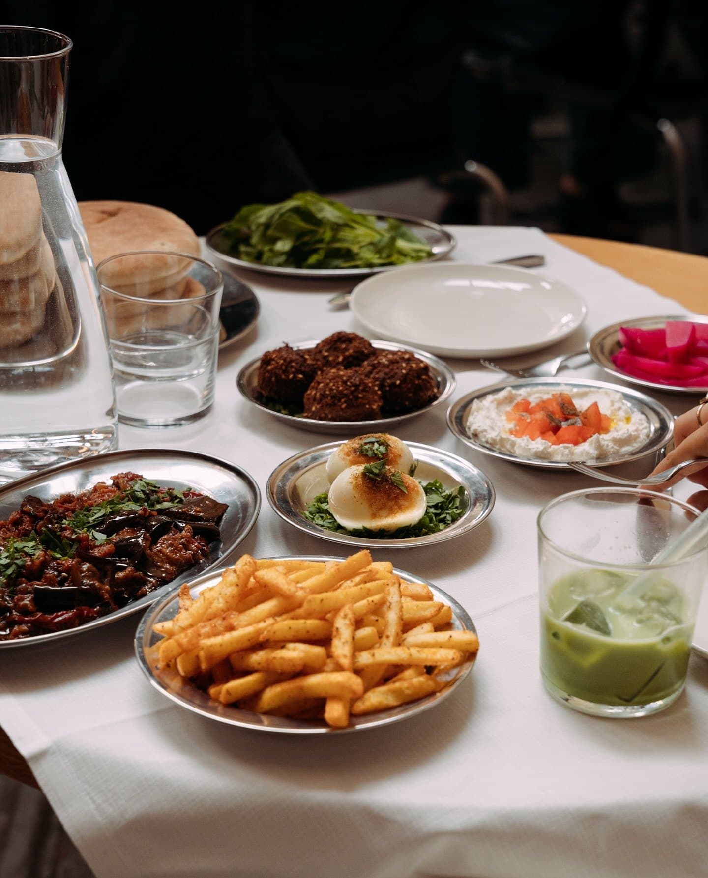 A full table with Egyptian food and dips